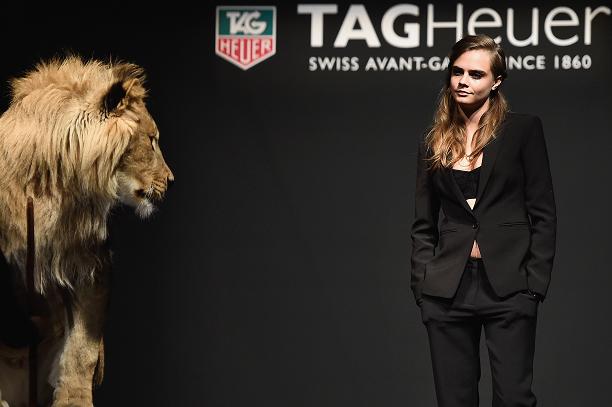 Cara Delevigne catwalking with a lion