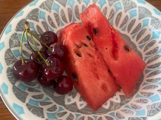 Cherries and watermelon in a colorful bow;